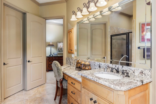 bathroom with vanity, an enclosed shower, ornamental molding, and tile patterned flooring