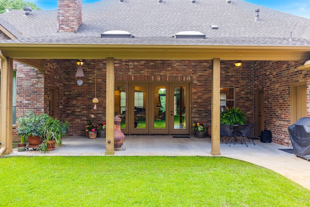 rear view of house featuring a patio, french doors, and a yard