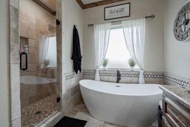 bathroom featuring vanity, independent shower and bath, ornamental molding, and tile walls