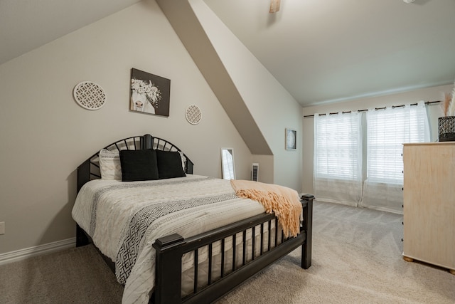 bedroom with carpet flooring and vaulted ceiling