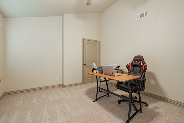 home office featuring vaulted ceiling and light colored carpet