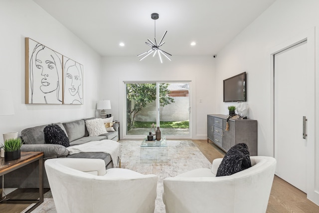 living room with light hardwood / wood-style flooring and a chandelier