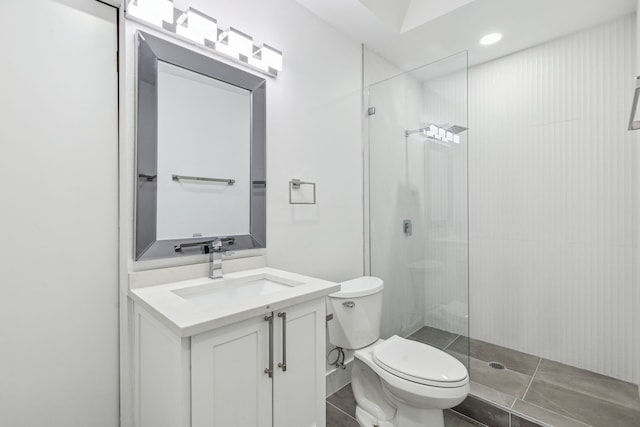 bathroom with vanity, toilet, tile patterned floors, and walk in shower