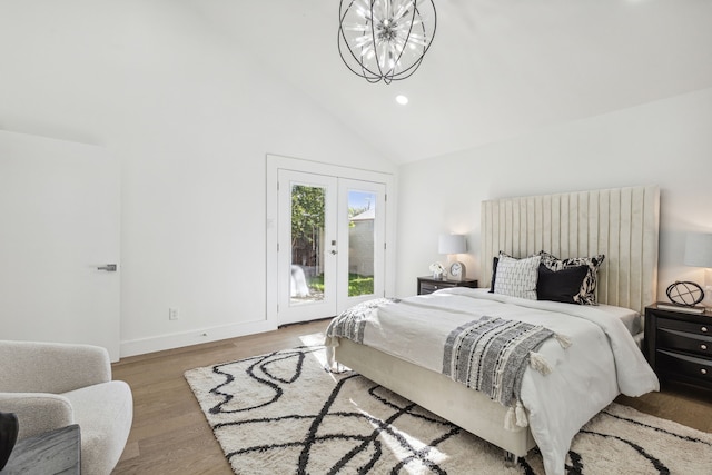 bedroom with access to exterior, high vaulted ceiling, a chandelier, wood-type flooring, and french doors