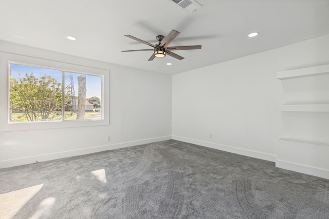 carpeted spare room with ceiling fan