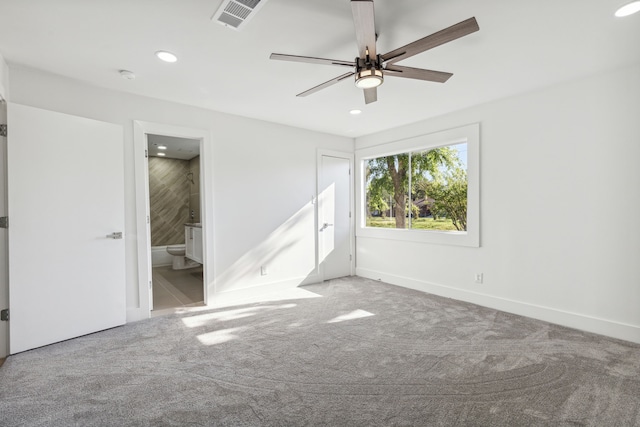 unfurnished bedroom featuring ensuite bath, carpet floors, and ceiling fan