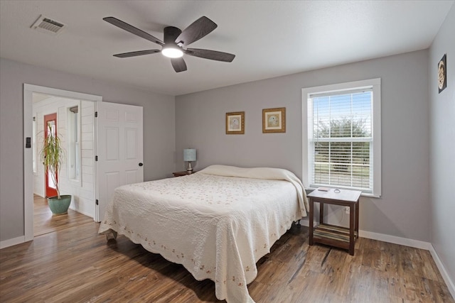 bedroom with ceiling fan and dark hardwood / wood-style flooring