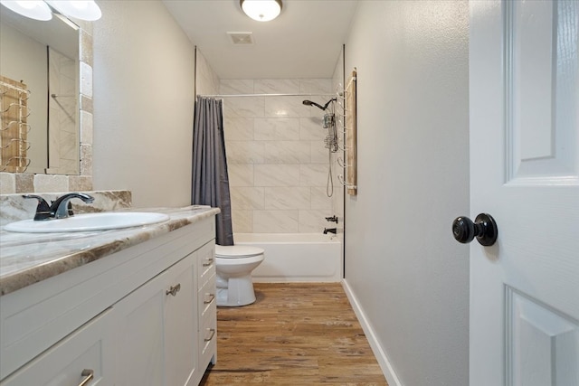 bathroom featuring vanity, shower / bathtub combination with curtain, wood finished floors, visible vents, and toilet