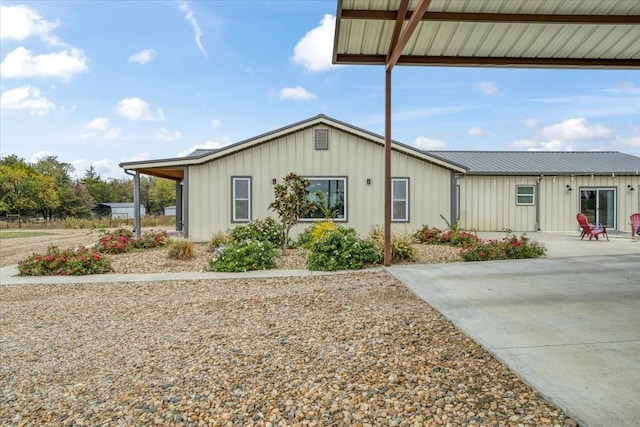 view of front of home featuring board and batten siding and metal roof