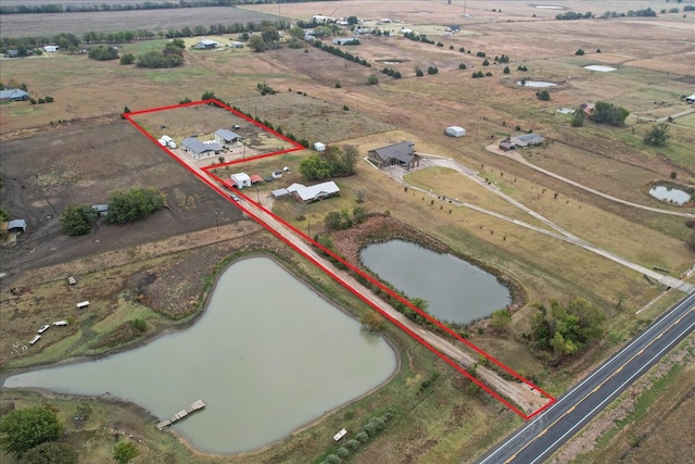 bird's eye view featuring a rural view and a water view