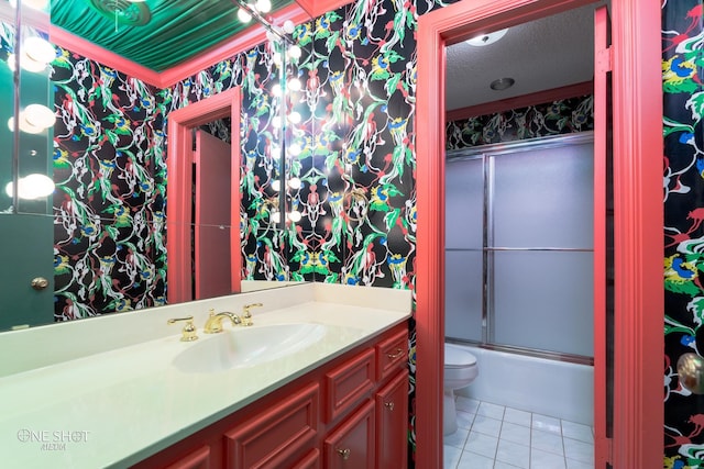 full bathroom featuring tile patterned floors, toilet, bath / shower combo with glass door, vanity, and a textured ceiling