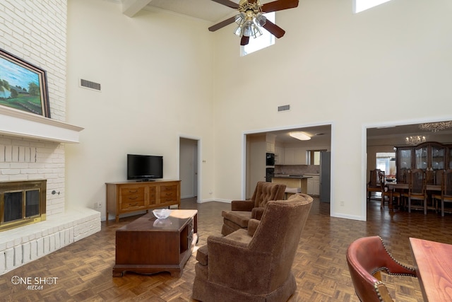 living room featuring a towering ceiling, dark parquet flooring, ceiling fan with notable chandelier, and a wealth of natural light