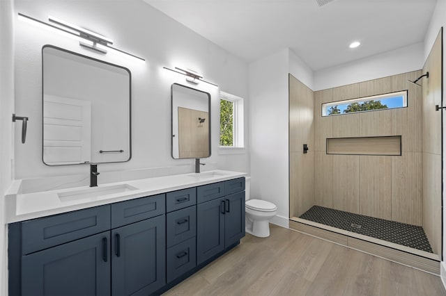 bathroom with vanity, hardwood / wood-style floors, toilet, and walk in shower