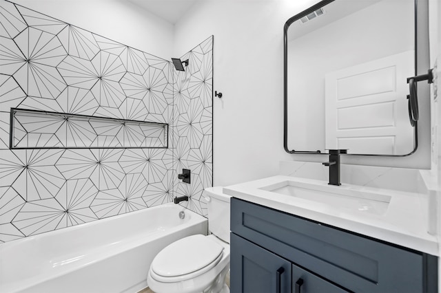 full bathroom featuring vanity, tiled shower / bath combo, and toilet