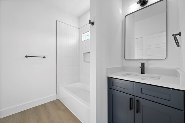 bathroom with vanity, hardwood / wood-style floors, and shower / bath combination