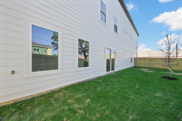 view of side of home featuring a yard