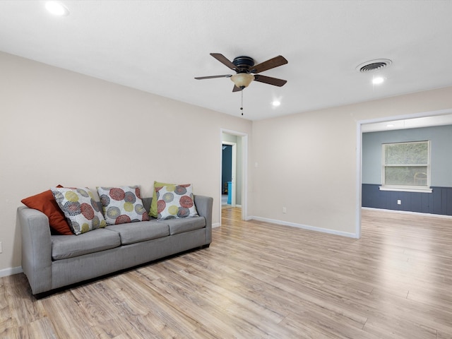 living room with ceiling fan and light hardwood / wood-style flooring