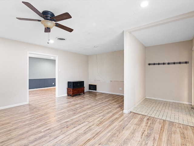 unfurnished living room featuring light hardwood / wood-style flooring and ceiling fan