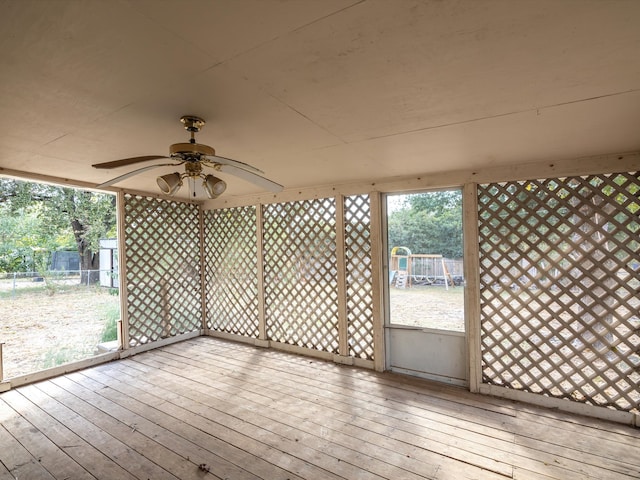 unfurnished sunroom with plenty of natural light and ceiling fan