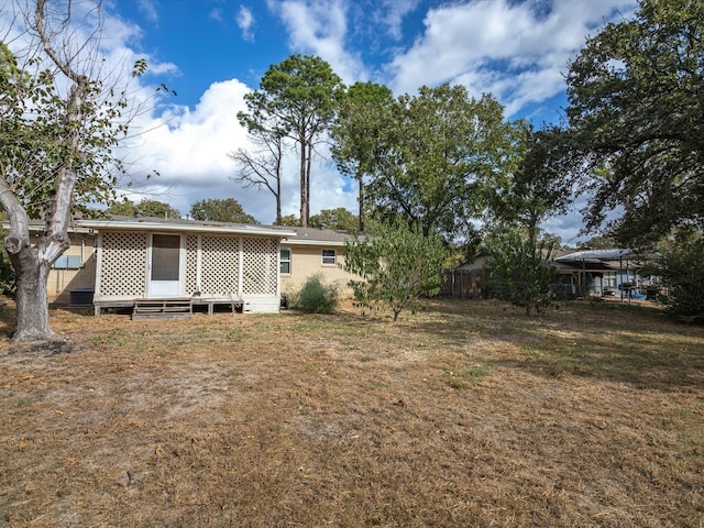 rear view of house with a yard