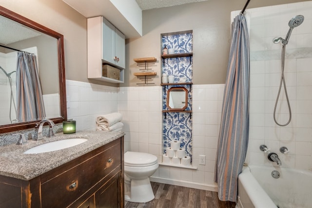 full bathroom with hardwood / wood-style floors, a textured ceiling, toilet, vanity, and tile walls