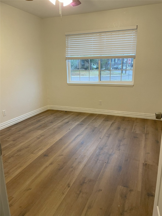 empty room featuring ceiling fan and hardwood / wood-style flooring