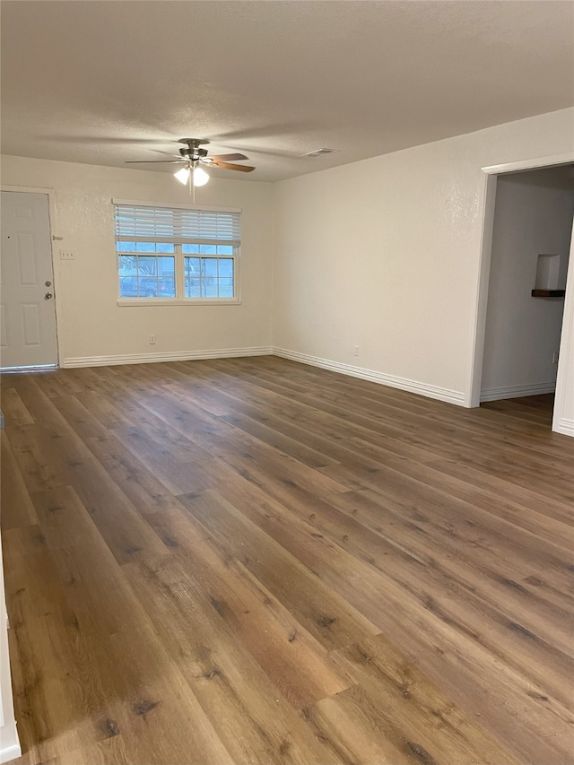 unfurnished room featuring ceiling fan, wood-type flooring, and a textured ceiling