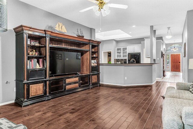 living room with dark wood-type flooring and ceiling fan