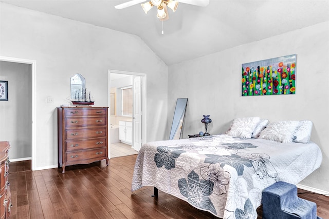 bedroom featuring ensuite bath, vaulted ceiling, dark hardwood / wood-style floors, and ceiling fan