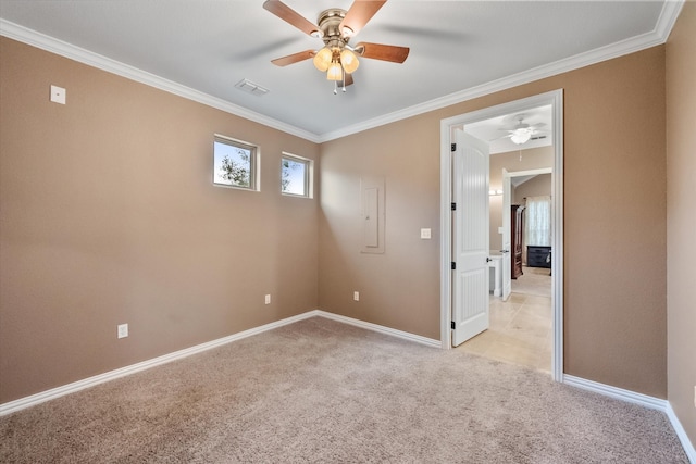 empty room featuring ornamental molding, light colored carpet, and ceiling fan