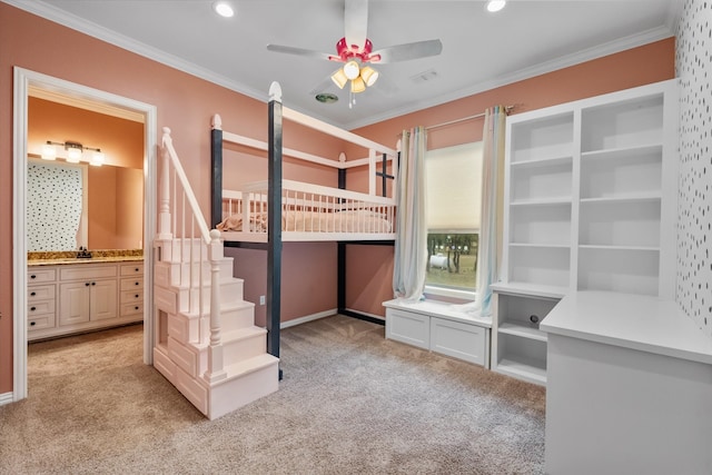 unfurnished bedroom featuring crown molding, light colored carpet, connected bathroom, and ceiling fan