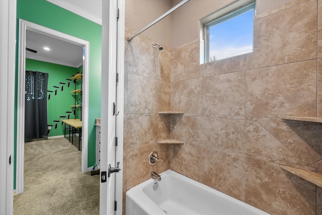 bathroom featuring crown molding and tiled shower / bath combo