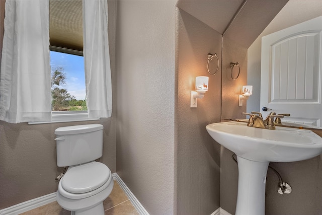 bathroom featuring toilet, tile patterned flooring, and vaulted ceiling