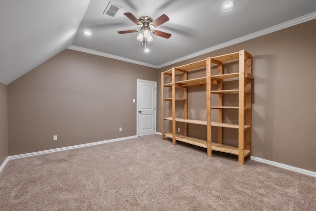 unfurnished bedroom featuring ceiling fan, crown molding, lofted ceiling, and carpet floors