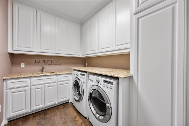 laundry room featuring cabinets, sink, separate washer and dryer, and dark hardwood / wood-style flooring