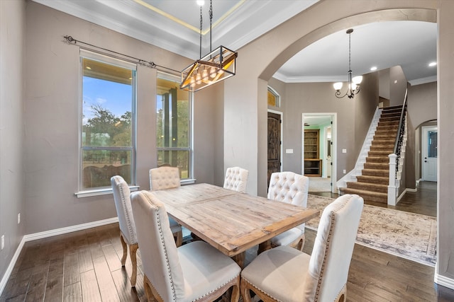 dining space featuring an inviting chandelier, crown molding, and dark hardwood / wood-style floors