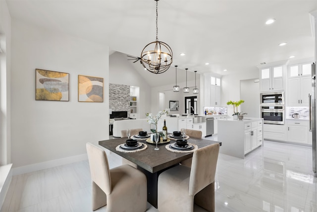 dining space with a chandelier, recessed lighting, vaulted ceiling, and baseboards