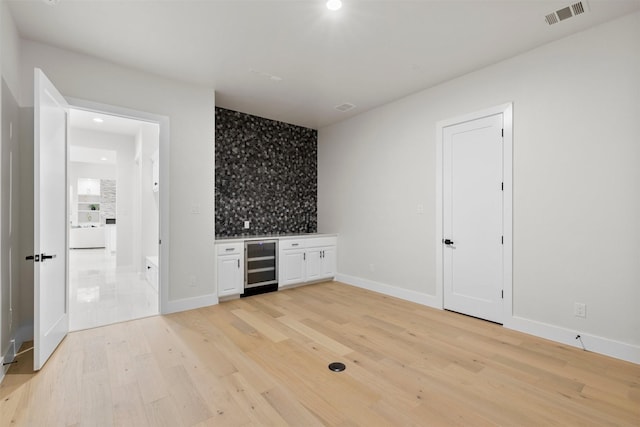 389 Arbor Mill Ct, Sunnyvale, TX 75182 - spare room featuring beverage cooler, a dry bar, light wood finished floors, recessed lighting, and baseboards