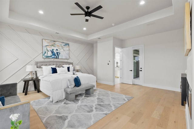 389 Arbor Mill Ct, Sunnyvale, TX 75182 - bedroom with a raised ceiling, light wood-style floors, baseboards, recessed lighting, and a decorative wall