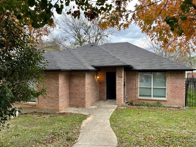 ranch-style home with a front yard