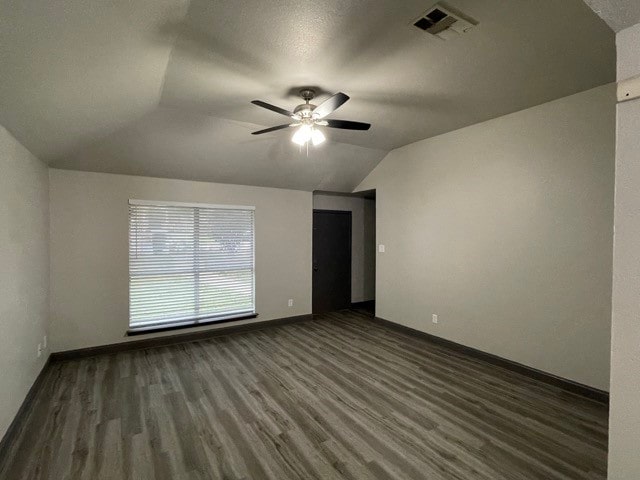 unfurnished room with vaulted ceiling, ceiling fan, and dark hardwood / wood-style flooring