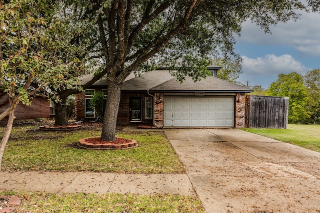 view of front of home featuring a front lawn and a garage