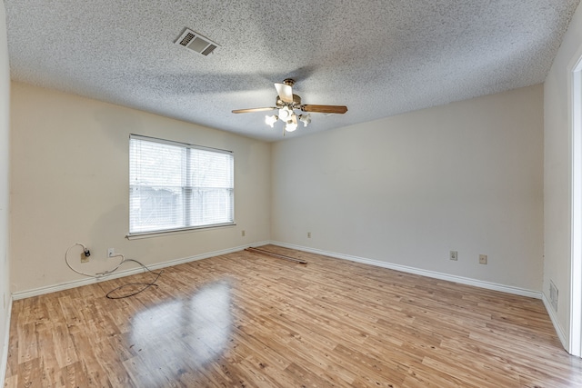 unfurnished room featuring a textured ceiling, light wood-type flooring, and ceiling fan