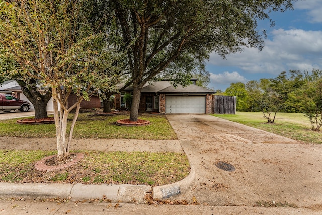 view of front of home with a front yard and a garage