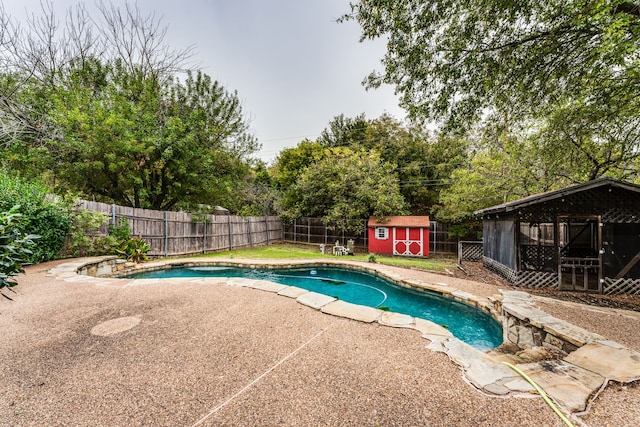 view of pool with a storage shed