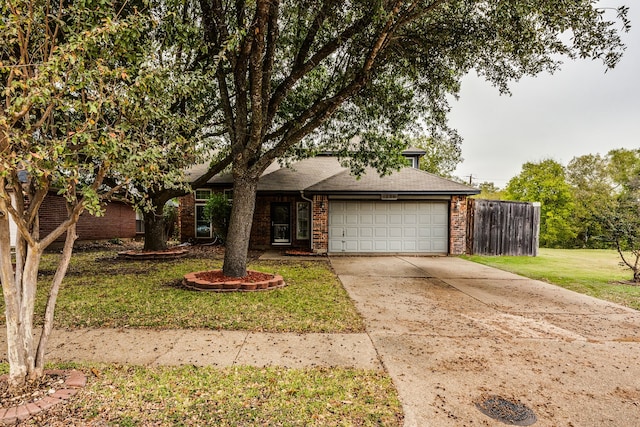 view of front of house with a front yard and a garage