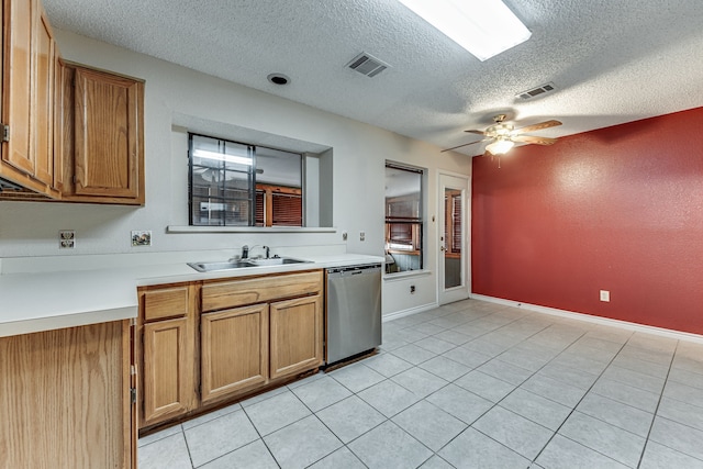 kitchen with sink, light tile patterned flooring, stainless steel dishwasher, a textured ceiling, and ceiling fan