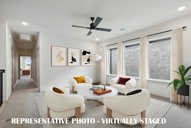 living room featuring light colored carpet and ceiling fan