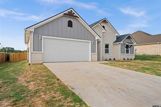 view of front facade with a front yard and a garage