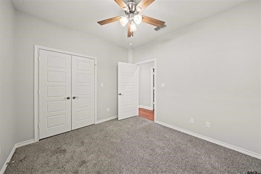 unfurnished bedroom featuring a closet, ceiling fan, and carpet floors